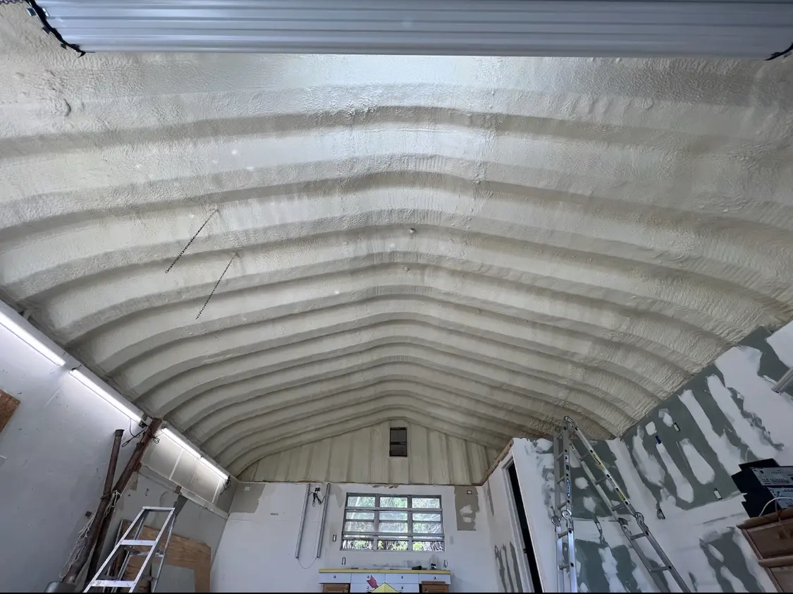 Spray polyurethane foam applied to the underside of a metal roof deck in Gallup
